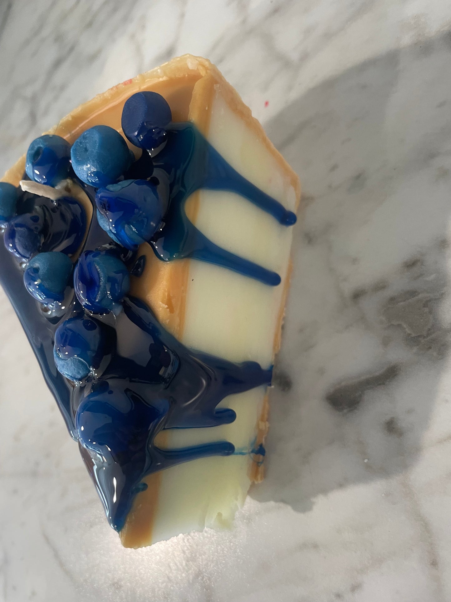 Slice of blueberry cheesecake candle