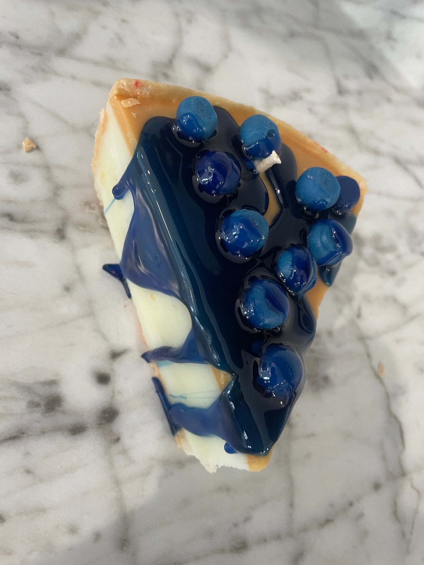 Slice of blueberry cheesecake candle