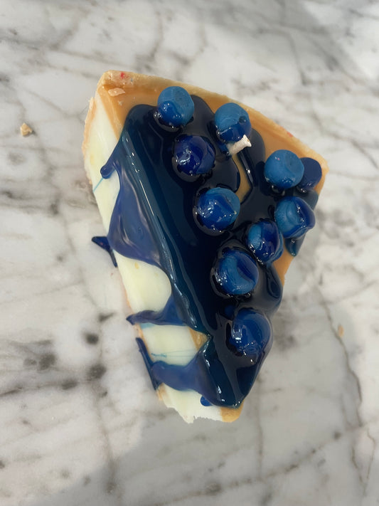 Slice of blueberry cheesecake candle