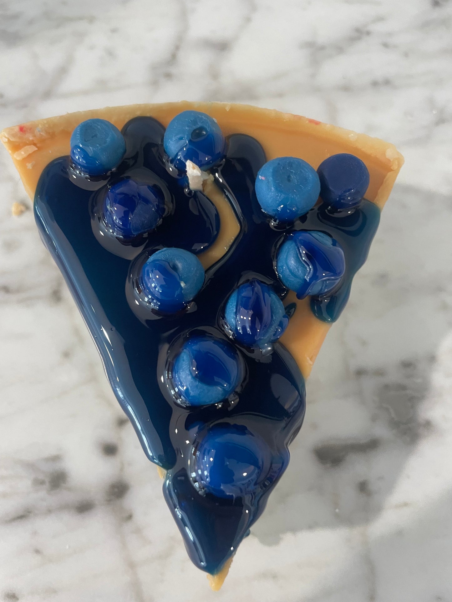 Slice of blueberry cheesecake candle