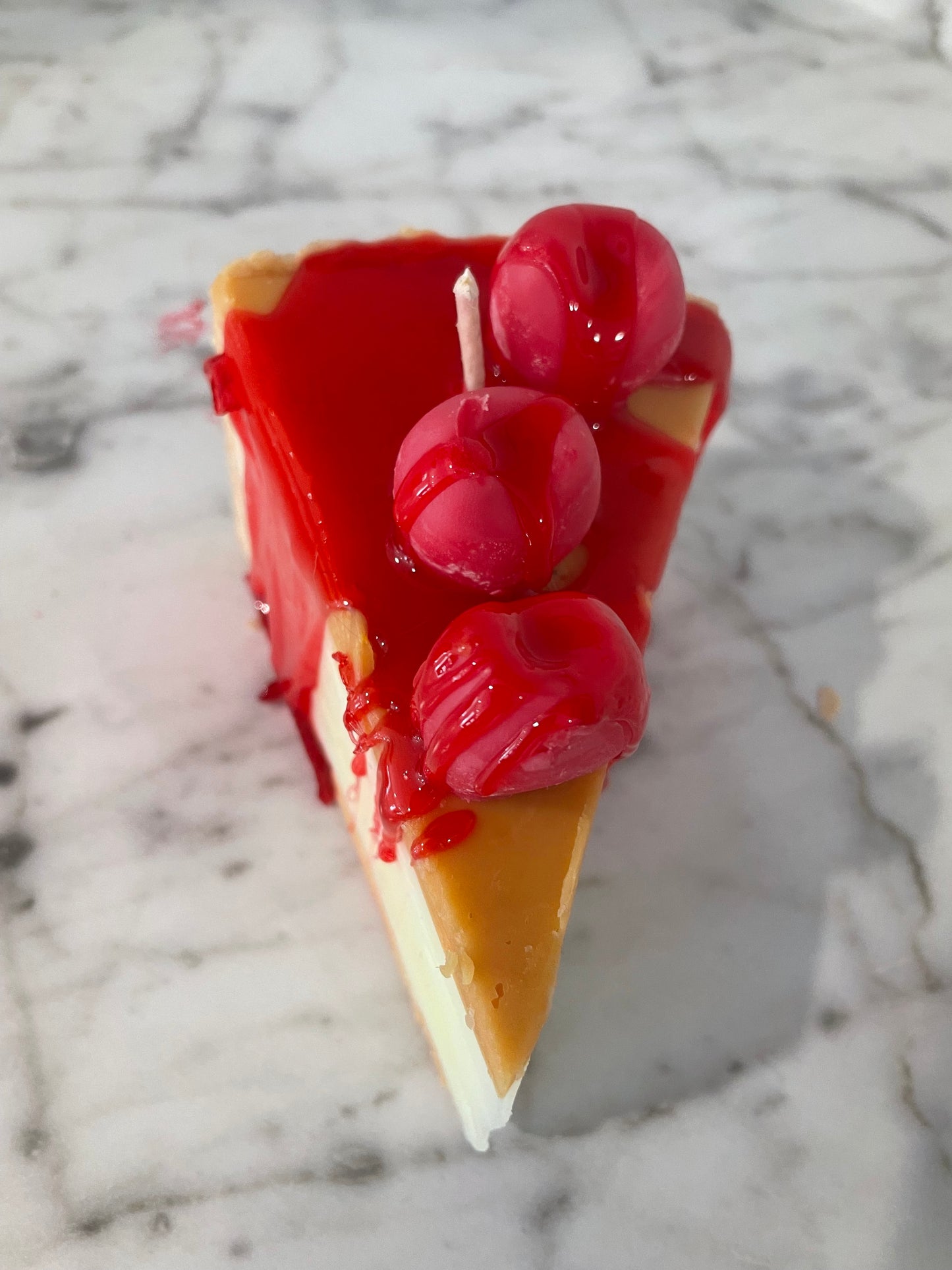 Slice of cherry cheesecake candle