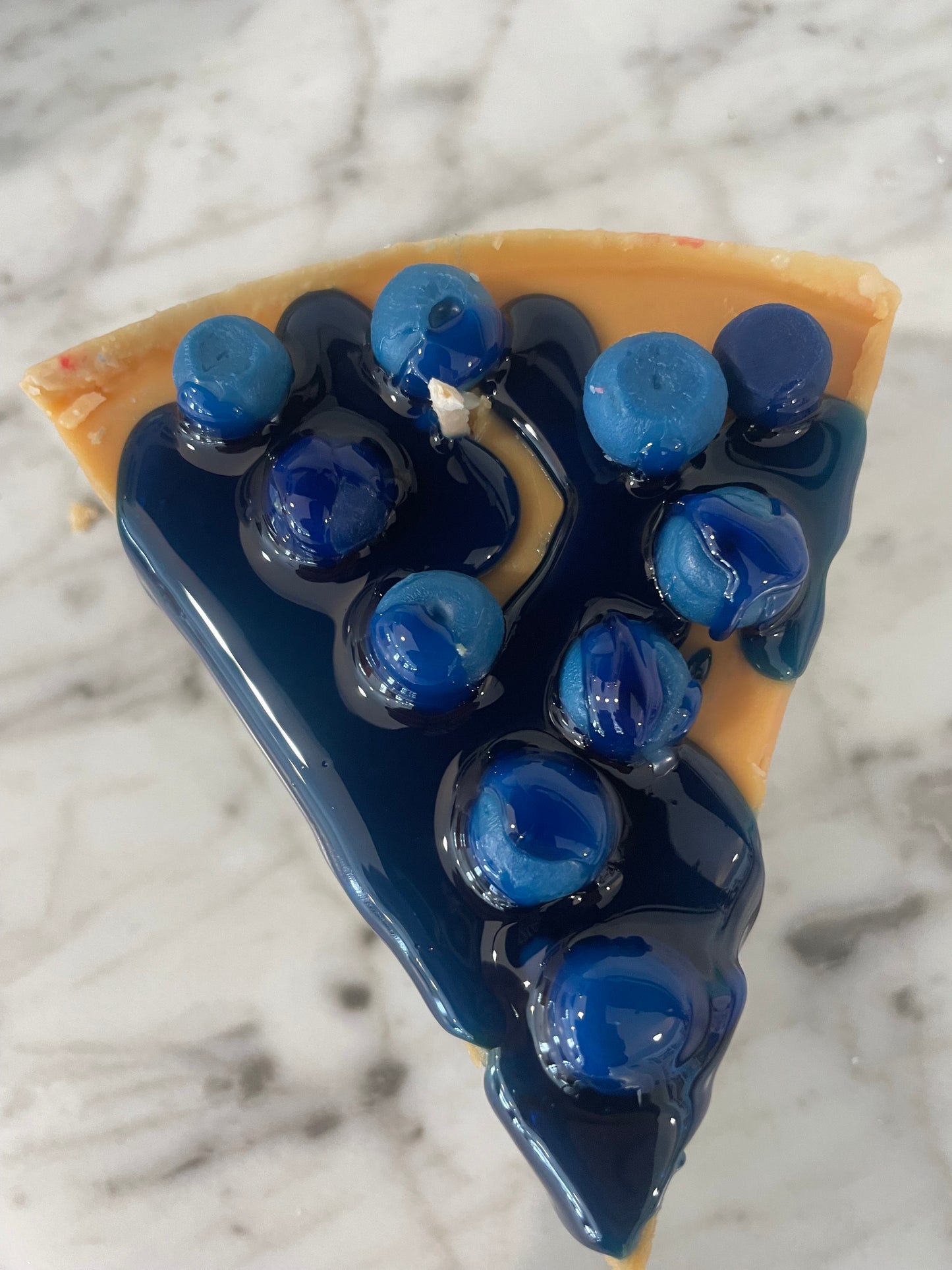 Slice of blueberry cheesecake candle